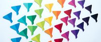 Colorful paper airplane formation flying in rainbow gradient pattern from blue to purple on white background for creative design projects.