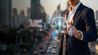 Professional businessman holding glowing digital justice scales hologram in modern city office environment representing legal technology and law services.