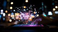 Magical glowing particles and bokeh lights bursting from digital tablet screen in dark environment, creating ethereal technology visualization effect.