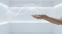 Hand holding glowing energy waves with flowing light streams on white background for technology and innovation concepts.