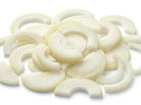 Fresh sliced white onion rings isolated on white background for cooking and culinary design projects.