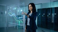 Young Hispanic businesswoman in suit interacts with futuristic transparent display showing data analytics in modern server room.