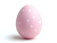 Pink Easter egg decorated with white star pattern on isolated white background, soft shadow adds depth. Festive spring holiday decoration.