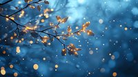 Glowing golden leaves on tree branches against deep blue night sky with magical bokeh lights and falling snow creating dreamy winter atmosphere.