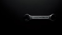 Chrome wrench tool isolated on black background for automotive repair and maintenance work. Professional mechanic equipment for garage and workshop use.