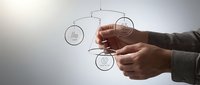 Professional businessman hands manipulating interconnected circular network diagrams representing business strategy and organizational structure planning.