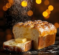 Fresh homemade brioche bread loaf with butter and powdered sugar falling, warm golden crust and soft texture on dark background with bokeh lights.