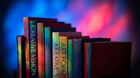 Row of colorful books on shelf with vibrant blue and pink neon lighting creating atmospheric glow for education and learning concepts.