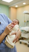 Nurse in blue scrubs gently holding a swaddled newborn baby in a modern hospital maternity ward, symbolizing care and new life.