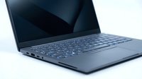 Closed laptop computer with dark blue metallic finish displayed at angle on white background, suitable for technology, business, and corporate design projects.