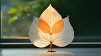 Autumn leaf with intricate vein patterns glowing in warm sunlight on windowsill, showcasing natural translucent texture and golden orange colors for seasonal decor.