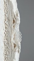 White mineral specimen with crystalline formations and granular texture on neutral background for geology and earth science educational materials.