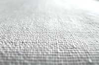 Close-up of light gray linen fabric texture with fine weave pattern, suitable for interior design, textile backgrounds, and upholstery projects.