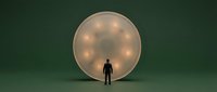 Man standing in front of glowing sphere against dark green background, representing innovation, technology, and future concepts for business and design projects.
