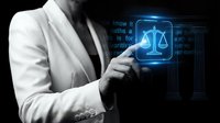Professional woman in business suit touching digital justice scales hologram interface with legal technology data visualization for law firm innovation.