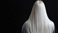 Long straight platinum blonde hair flowing down on black background, dramatic studio lighting highlighting silky smooth texture and shine. Professional hairstyle photography.