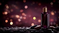 Elegant purple perfume bottle on dark stones against blurred bokeh background, creating luxurious atmosphere for fragrance advertising.