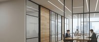 Modern office interior with glass partition walls, wooden door frames, and professional workspace setup. Contemporary corporate environment suitable for business, architecture, and workplace design projects.