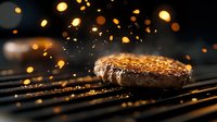 Juicy beef burger patty grilling on barbecue with flying sparks and glowing embers against dark background, dramatic food photography with bokeh effect.