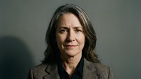 Professional mature businesswoman with gray hair in corporate suit portrait for executive leadership and career success concepts.