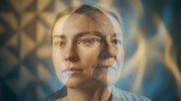 Young Caucasian woman with futuristic digital face mapping technology overlay showing geometric patterns and data visualization for AI analysis.