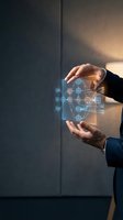 Businessman holding holographic network diagram with connected nodes and data flow visualization in hands against modern office background.