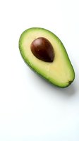 Fresh ripe avocado half with pit isolated on white background for healthy eating and cooking designs.