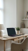 Modern minimalist home office workspace with laptop computer on wooden desk and green plant for remote work productivity and freelance business setup.
