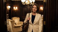 Professional middle-aged Caucasian businesswoman in beige blazer holding champagne glass in elegant hotel lobby with warm lighting and luxury furniture.