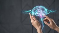 Human hands protecting glowing digital brain with neural networks and electric energy waves against dark geometric background for AI technology concepts.