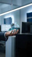 Businessman hand displaying holographic digital technology icons in modern office environment for innovation and future business concepts.