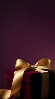 Luxury gift box wrapped in burgundy velvet with elegant gold satin ribbon bow against deep purple background, perfect for holiday, celebration, and premium packaging design projects.