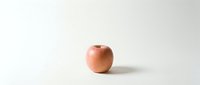 Fresh red apple on clean white background with soft shadow, minimalist composition for healthy eating and nutrition concepts.