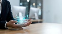 Businessman hands holding glowing digital network connections with data particles in modern office environment for technology and innovation concepts.