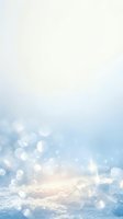 Soft winter background with blurred bokeh lights and ice crystals on snow, ideal for seasonal designs and holiday projects.