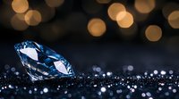 Sparkling blue diamond on dark surface with golden bokeh lights in background creates luxurious atmosphere. Precious gem reflects and refracts light dramatically.
