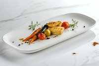 Grilled carrots with roasted cherry tomatoes and herb garnish served on white ceramic plate against marble background. Fine dining presentation.