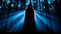 Mysterious hooded figure silhouetted against ethereal blue light rays in misty dark forest at night, creating dramatic supernatural atmosphere.