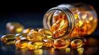 Golden omega-3 fish oil capsules spilling from glass jar on dark wooden surface. Health supplement vitamins for wellness and nutrition support.