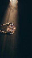Hands holding glowing energy orb with mystical light beam from above creating magical atmosphere for fantasy and spiritual concepts.