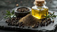 Ground and whole black peppercorns with olive oil in glass bottle on dark stone background, aromatic spices and herbs for cooking.
