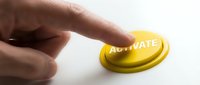Caucasian male hand pressing yellow button with text on white background, automation concept for business processes and workflow efficiency.