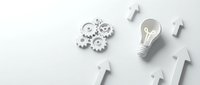 Gears, light bulb with leaf symbol, and upward arrows on white background representing innovation, growth, and sustainable business strategy.