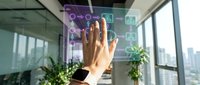 Professional hand touching interactive digital display with network icons and data visualization in modern office environment with city skyline view.