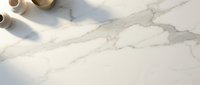 Elegant white marble surface with natural gray veining and golden ceramic bowls in soft natural lighting for luxury interior design and product photography.