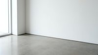 Empty modern room corner with polished concrete floor and white walls near large window for interior design and architectural projects.