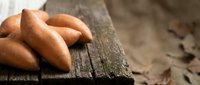 Fresh baked bread rolls on rustic wooden surface, ideal for bakery, food, and culinary content.