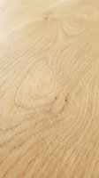 Close-up of light oak wood flooring with natural grain patterns and knots, showcasing texture for interior design, construction, and home renovation projects.