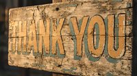 Rustic wooden thank you sign with embossed lettering on weathered wood surface, suitable for gratitude messaging, rustic decor, and appreciation themes.