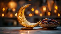 Decorative golden crescent moon with traditional dates in bowl against blurred bokeh lights background, Ramadan and Eid celebration atmosphere.